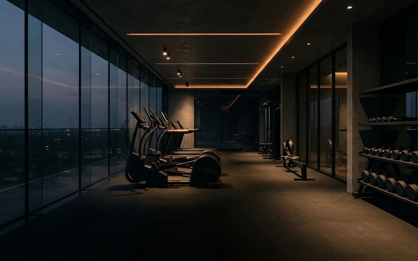 Gimnasio residencial moderno con ventanales panorámicos y equipo de entrenamiento de alta gama