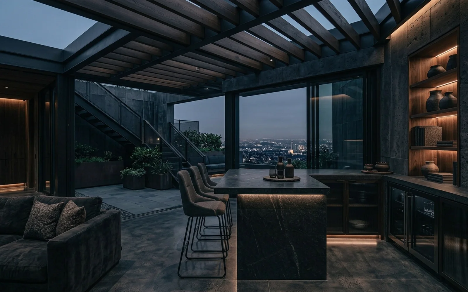 Terraza con kitchenette exterior, barra y vista nocturna a la ciudad